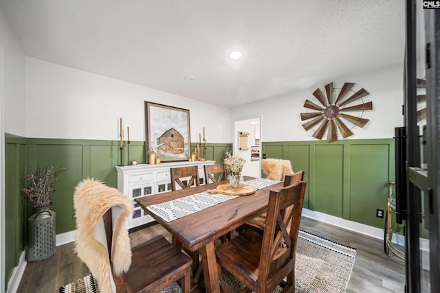173 Snow Ln, Lexington, SC 29073 - dining area with a wainscoted wall, dark wood-style flooring, a textured ceiling, a decorative wall, and recessed lighting