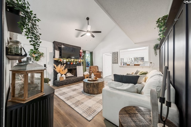 173 Snow Ln, Lexington, SC 29073 - living area featuring a ceiling fan, wood finished floors, vaulted ceiling, and a stone fireplace