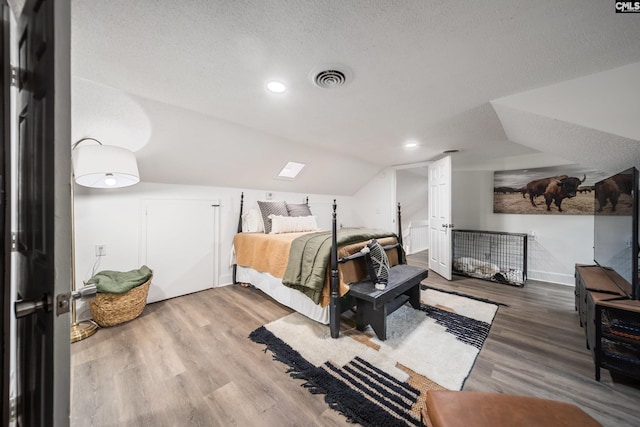 173 Snow Ln, Lexington, SC 29073 - bedroom with vaulted ceiling, wood finished floors, recessed lighting, and a textured ceiling