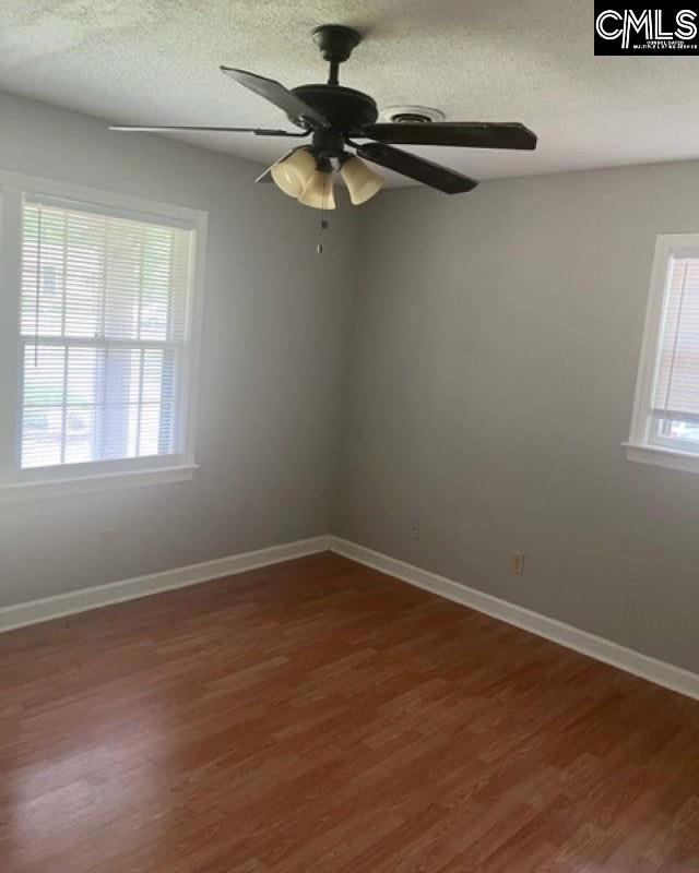 264 Piney Grove Rd, Columbia, SC 29210 - spare room featuring healthy amount of natural light, wood finished floors, baseboards, a ceiling fan, and a textured ceiling
