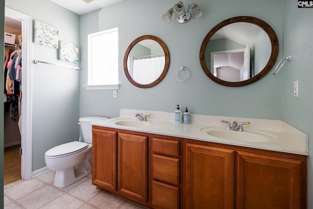 307 Swallowtail Ln, West Columbia, SC 29169 - bathroom featuring double vanity, toilet, a walk in closet, and tile patterned floors