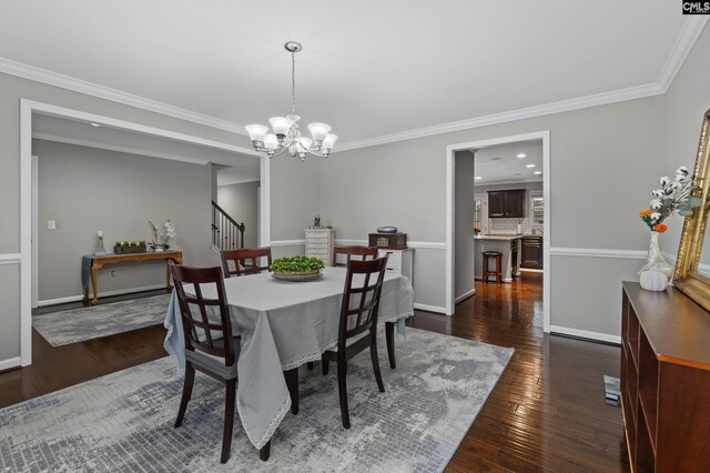 2 Casey Dr, Elgin, SC 29045 - dining room featuring a chandelier, dark wood finished floors, crown molding, baseboards, and stairs