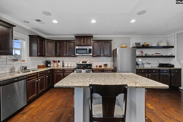 2 Casey Dr, Elgin, SC 29045 - kitchen featuring appliances with stainless steel finishes, a sink, backsplash, crown molding, and dark wood finished floors