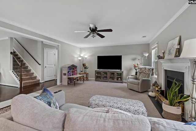 2 Casey Dr, Elgin, SC 29045 - carpeted living room with ceiling fan, stairway, ornamental molding, a fireplace with flush hearth, and baseboards