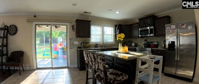 1 Twinspur Ct, Columbia, SC 29229 - kitchen with appliances with stainless steel finishes, a sink, decorative backsplash, light stone countertops, and crown molding