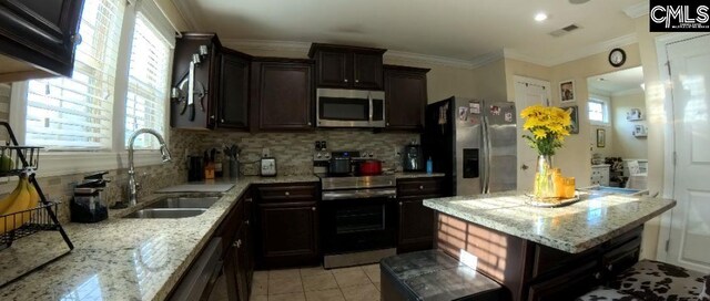 1 Twinspur Ct, Columbia, SC 29229 - kitchen featuring appliances with stainless steel finishes, a sink, decorative backsplash, light stone countertops, and ornamental molding