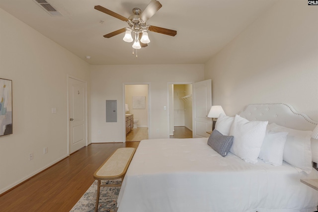 1085 Shop Rd Unit 337, Columbia, SC 29201 - bedroom with wood finished floors, electric panel, a walk in closet, baseboards, and a ceiling fan