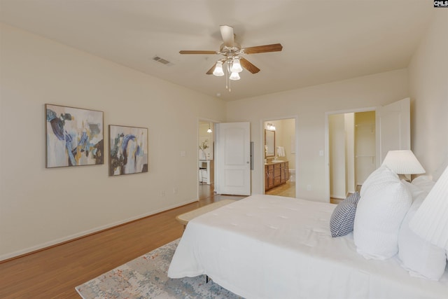 1085 Shop Rd Unit 337, Columbia, SC 29201 - bedroom with light wood finished floors, baseboards, connected bathroom, ceiling fan, and a walk in closet