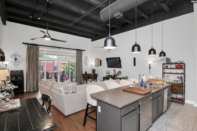 1049 Key Rd Unit 22, Columbia, SC 29201 - kitchen featuring open floor plan, gray cabinetry, rail lighting, a breakfast bar, and pendant lighting