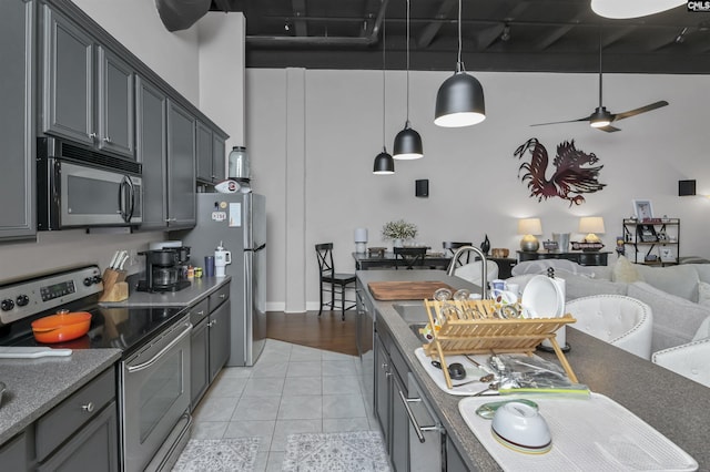 1049 Key Rd Unit 22, Columbia, SC 29201 - kitchen featuring appliances with stainless steel finishes, light tile patterned floors, open floor plan, dark countertops, and a sink