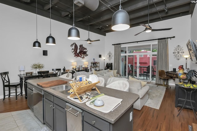 1049 Key Rd Unit 22, Columbia, SC 29201 - kitchen featuring gray cabinetry, ceiling fan, open floor plan, dishwasher, and a high ceiling