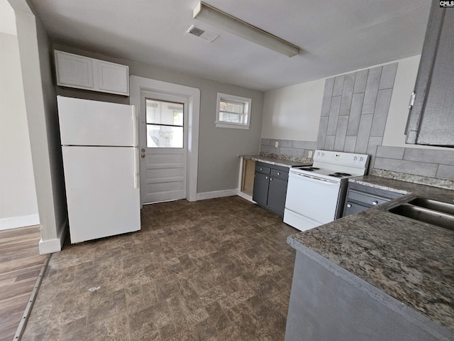 202 Crawford Rd, Columbia, SC 29203 - kitchen featuring white appliances, baseboards, tasteful backsplash, a sink, and white cabinets