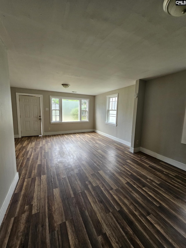202 Crawford Rd, Columbia, SC 29203 - unfurnished living room featuring dark wood finished floors, baseboards, and healthy amount of natural light