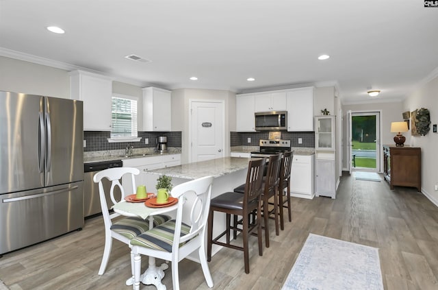 206 Carriagebrook Cir, Camden, SC 29020 - kitchen with appliances with stainless steel finishes, crown molding, a center island, tasteful backsplash, and a sink