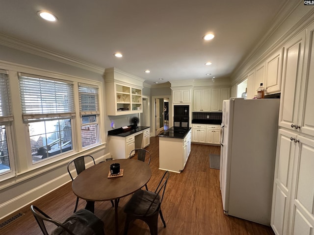 219 Mallet Hill Rd, Columbia, SC 29223 - kitchen with black appliances, dark countertops, a kitchen island, dark wood finished floors, and white cabinetry