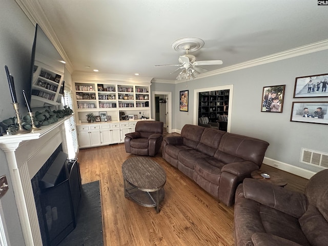 219 Mallet Hill Rd, Columbia, SC 29223 - living room with ceiling fan, a fireplace, crown molding, wood finished floors, and baseboards