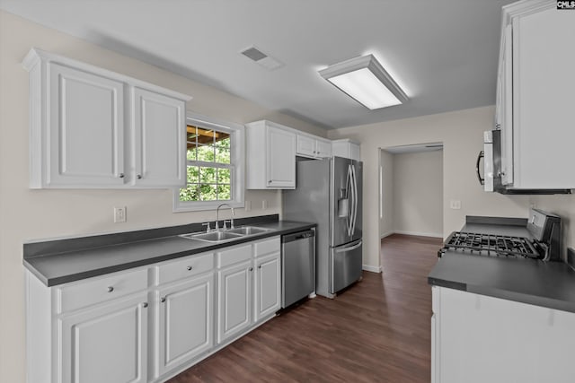 116 Harmon Creek Ct, Lexington, SC 29072 - kitchen featuring appliances with stainless steel finishes, a sink, dark countertops, white cabinets, and dark wood-style floors