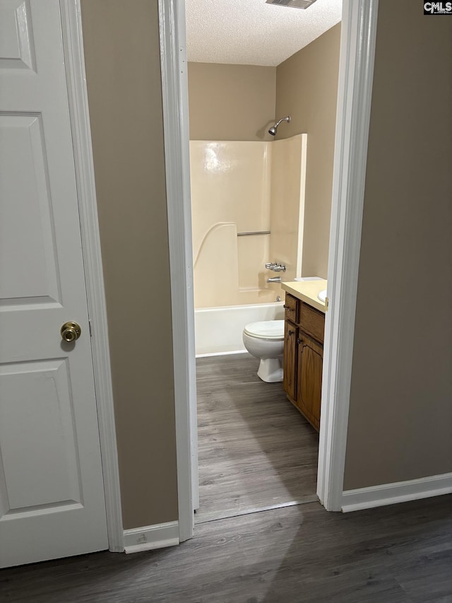 6 Bradley Ct Unit B, Cayce, SC 29033 - full bathroom with vanity, wood finished floors, shower / bathtub combination, toilet, and a textured ceiling