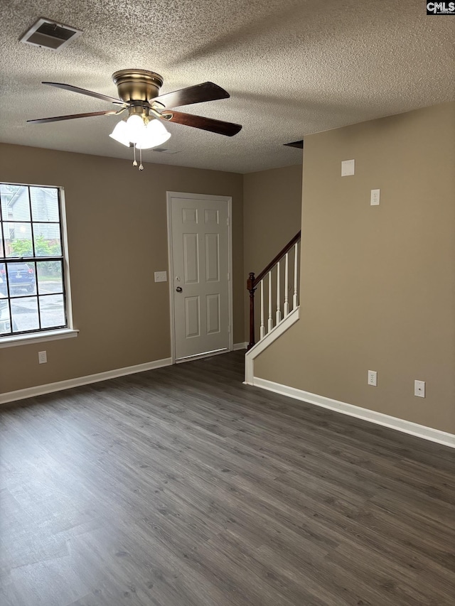 6 Bradley Ct Unit B, Cayce, SC 29033 - unfurnished room with stairs, dark wood-type flooring, a ceiling fan, a textured ceiling, and baseboards