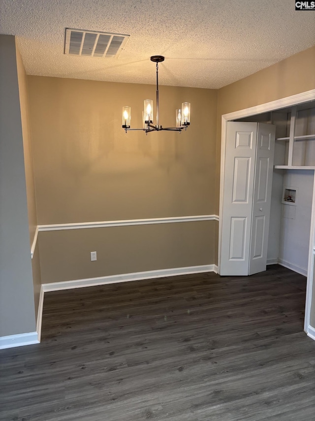 6 Bradley Ct Unit B, Cayce, SC 29033 - unfurnished dining area with a chandelier, dark wood-style floors, a textured ceiling, and baseboards