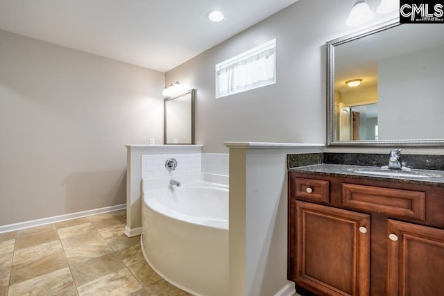 1811 Wildwood Ln, Elgin, SC 29045 - bathroom with a bath, vanity, and baseboards