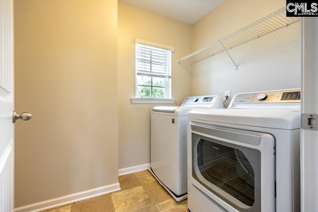 1811 Wildwood Ln, Elgin, SC 29045 - washroom with washing machine and clothes dryer, baseboards, and light tile patterned floors