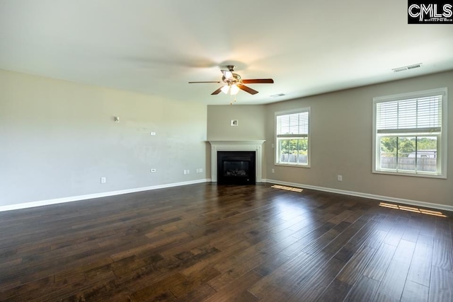 1811 Wildwood Ln, Elgin, SC 29045 - unfurnished living room with ceiling fan, baseboards, a glass covered fireplace, and dark wood-style flooring