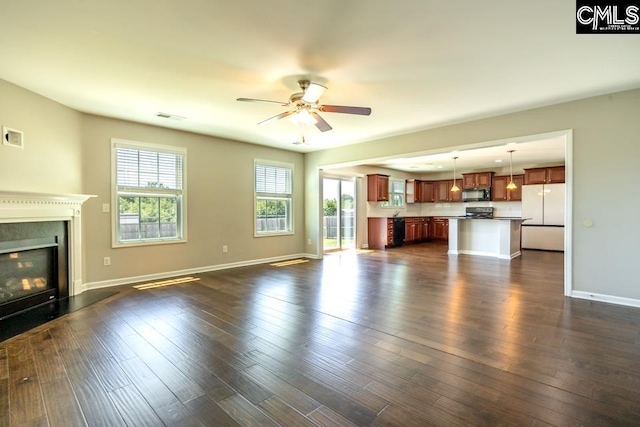 1811 Wildwood Ln, Elgin, SC 29045 - unfurnished living room with a glass covered fireplace, ceiling fan, baseboards, and dark wood-type flooring