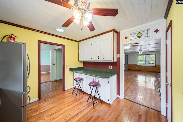 108 Commonwealth Ct, Lexington, SC 29073 - kitchen with freestanding refrigerator, ceiling fan, dark countertops, white cabinetry, and crown molding