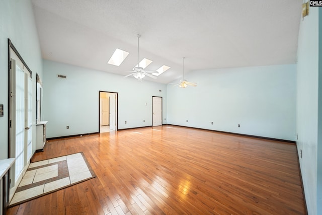 108 Commonwealth Ct, Lexington, SC 29073 - spare room featuring vaulted ceiling, a skylight, ceiling fan, light wood-style flooring, and baseboards