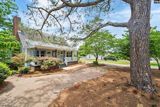 108 Commonwealth Ct, Lexington, SC 29073 - view of front of property featuring a porch, driveway, roof with shingles, and a chimney