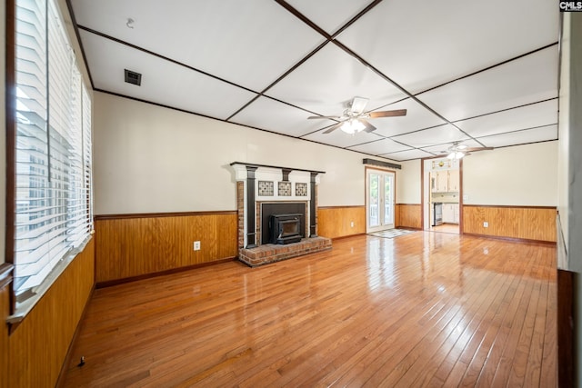 108 Commonwealth Ct, Lexington, SC 29073 - unfurnished living room featuring ceiling fan, wainscoting, hardwood / wood-style flooring, wooden walls, and a fireplace