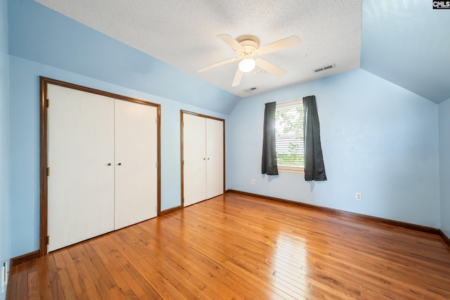 108 Commonwealth Ct, Lexington, SC 29073 - unfurnished bedroom with multiple closets, vaulted ceiling, hardwood / wood-style flooring, a textured ceiling, and ceiling fan