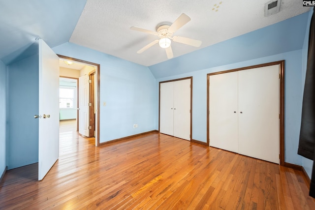 108 Commonwealth Ct, Lexington, SC 29073 - unfurnished bedroom with multiple closets, light wood-type flooring, lofted ceiling, and a ceiling fan