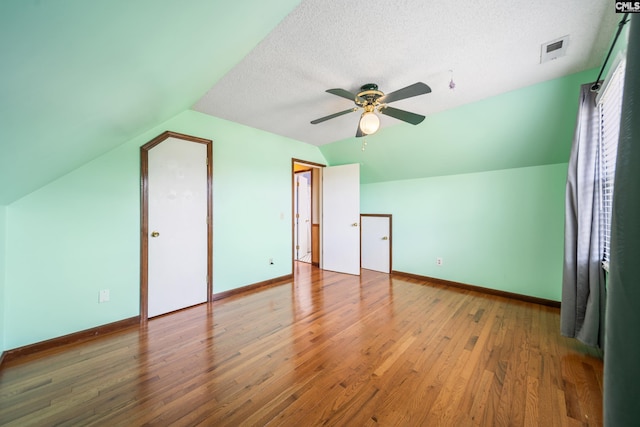 108 Commonwealth Ct, Lexington, SC 29073 - additional living space featuring vaulted ceiling, ceiling fan, wood finished floors, baseboards, and a textured ceiling