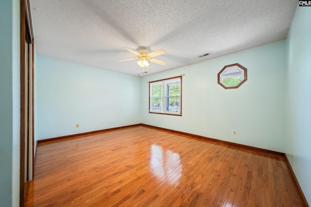 108 Commonwealth Ct, Lexington, SC 29073 - unfurnished room with ceiling fan, baseboards, hardwood / wood-style floors, and a textured ceiling