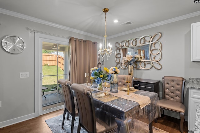 1020 Cameron Ridge Dr, Columbia, SC 29209 - dining area featuring wood finished floors, ornamental molding, a chandelier, and baseboards