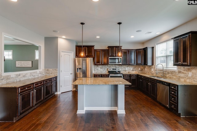 145 Decoy Ct, Sumter, SC 29145 - kitchen with stainless steel appliances, a sink, dark brown cabinets, light stone counters, and recessed lighting