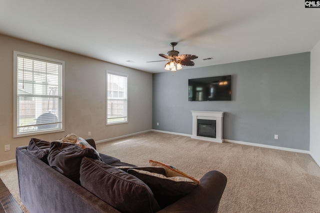 145 Decoy Ct, Sumter, SC 29145 - living area featuring a glass covered fireplace, baseboards, a ceiling fan, and carpet