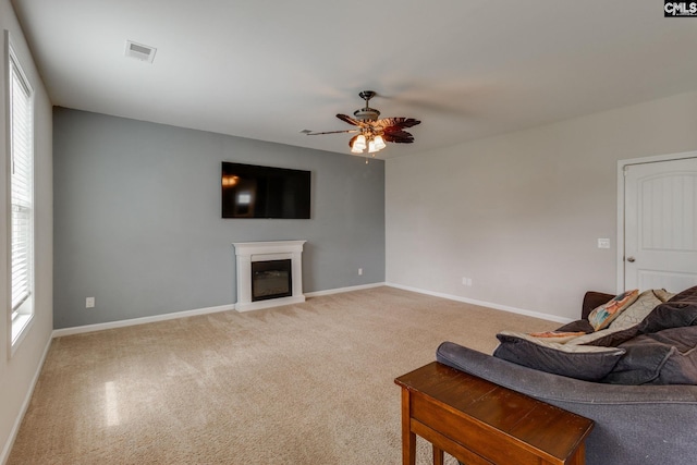 145 Decoy Ct, Sumter, SC 29145 - living room with a ceiling fan, a glass covered fireplace, light carpet, and baseboards