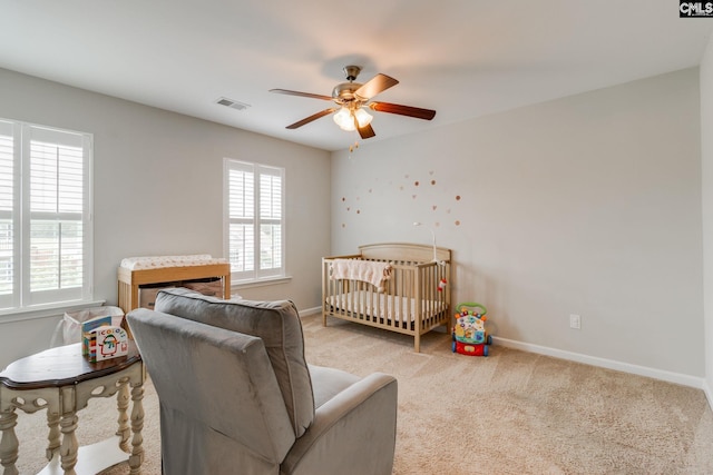 145 Decoy Ct, Sumter, SC 29145 - carpeted bedroom featuring baseboards, ceiling fan, and a nursery area