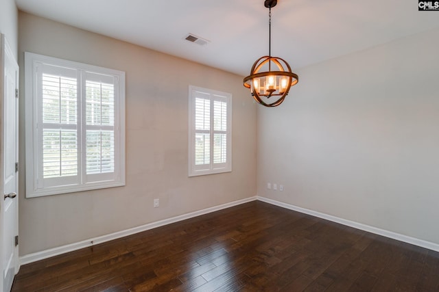 145 Decoy Ct, Sumter, SC 29145 - empty room featuring a chandelier, dark wood-type flooring, and baseboards