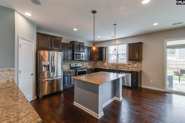 145 Decoy Ct, Sumter, SC 29145 - kitchen with stainless steel appliances, a sink, dark brown cabinets, plenty of natural light, and recessed lighting