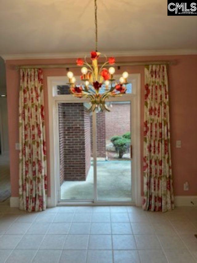 117 York Commons, Lexington, SC 29072 - unfurnished dining area with a chandelier, ornamental molding, and tile patterned flooring