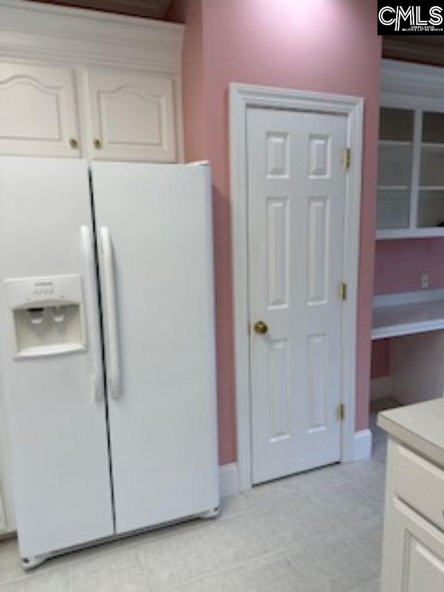 117 York Commons, Lexington, SC 29072 - kitchen featuring white refrigerator with ice dispenser, white cabinetry, light countertops, and light tile patterned floors