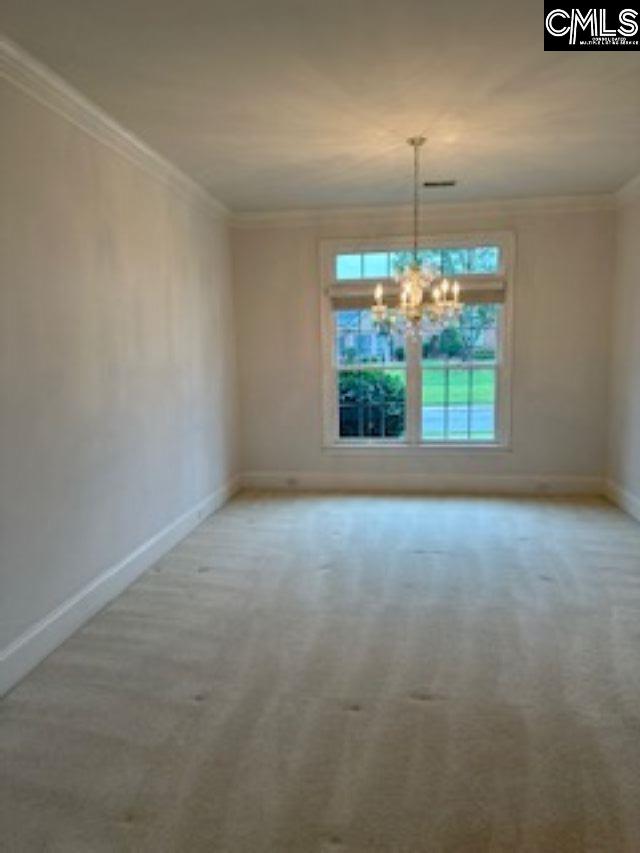 117 York Commons, Lexington, SC 29072 - unfurnished dining area with ornamental molding, a chandelier, baseboards, and carpet flooring