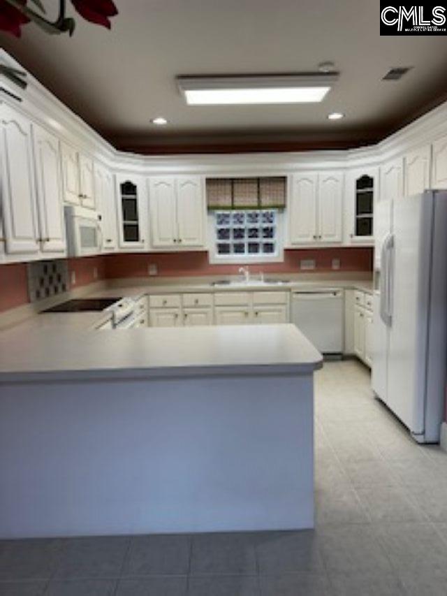 117 York Commons, Lexington, SC 29072 - kitchen featuring white appliances, a peninsula, a sink, glass insert cabinets, and recessed lighting