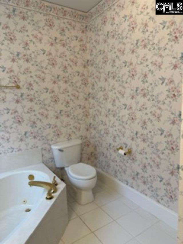 117 York Commons, Lexington, SC 29072 - full bathroom featuring wallpapered walls, toilet, baseboards, a tub with jets, and tile patterned floors