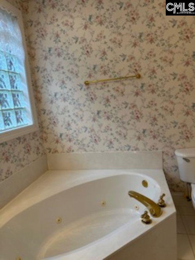 117 York Commons, Lexington, SC 29072 - bathroom featuring wallpapered walls, a jetted tub, toilet, and tile patterned flooring