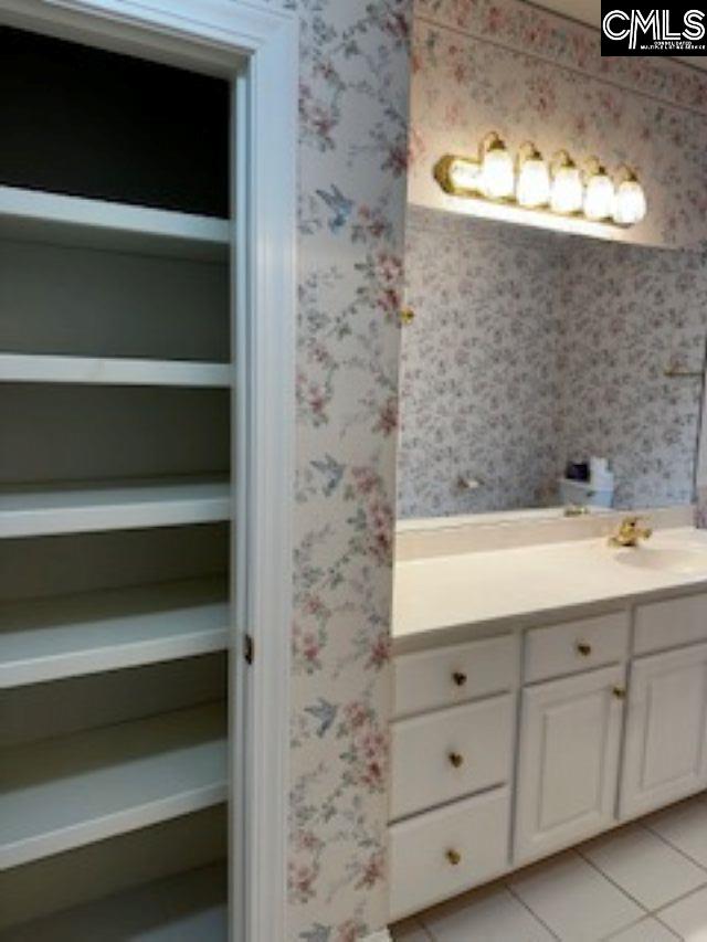 117 York Commons, Lexington, SC 29072 - bathroom featuring vanity, tile patterned floors, and wallpapered walls